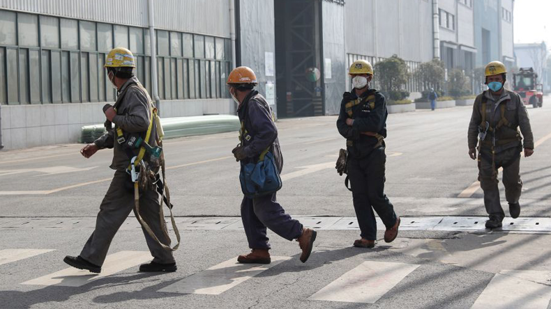 Shipyard workers at Nantong after the Chinese New Year holidays, with anti-coronavirus masks