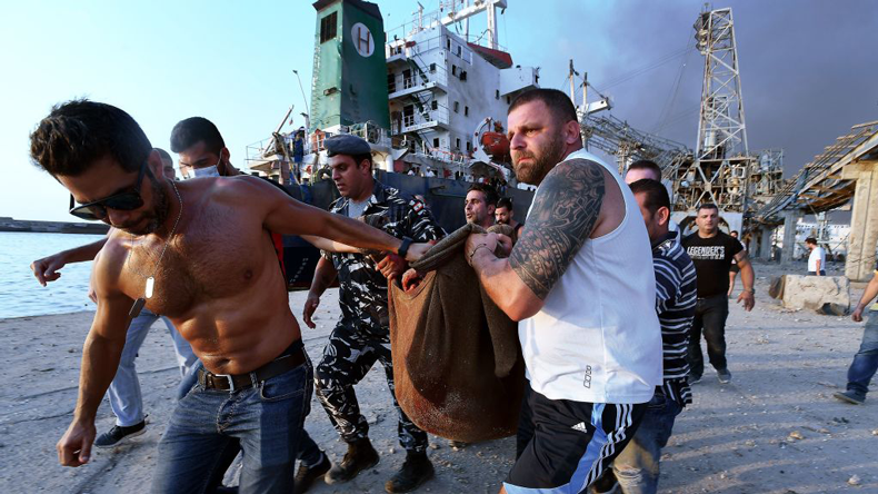 Beirut blast Aug 04: Wounded man being carried from the docks. Credit: AFP via Getty Images