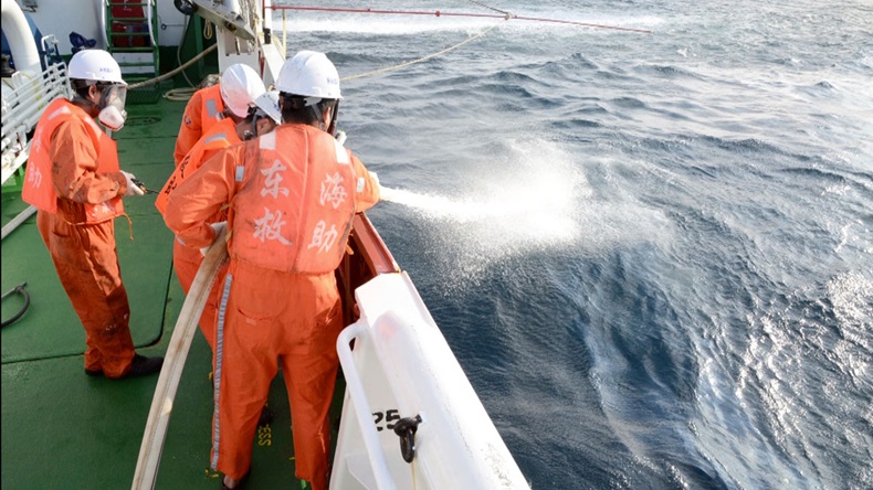 Spraying an oil slick from the stricken tanker Sanchi