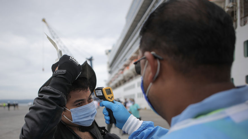 Covid temperature check for cruise passenger. Credit  Mauricio Valenzuela/AFP via Getty Images