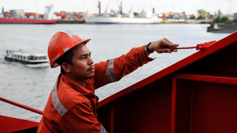Filipino seafarer painting on ship while in Hamburg
