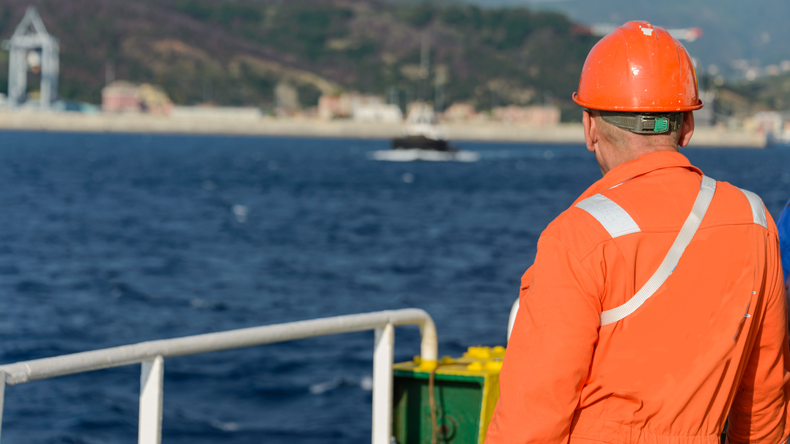 Lone seafarer gazes at the shore: credit Alexey Seafarer/Shutterstock.com