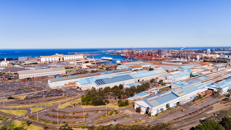 Port Kembla Mills Close - stock photo Mills, warehouses and storage yards of Port Kembla industrial site and sea port near Wollongong in Australia. Elevated aerial view across site towards open sea on a sunny day