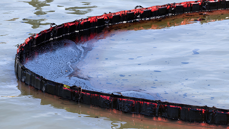 floating barrier to dam oil pollution Credit: Bjorn Wylezich / Alamy Stock Photo