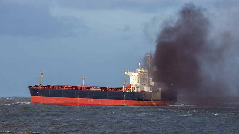 Industrial cargo ship causing air pollution black smoke Credit: JLBvdWOLF / Alamy Stock Photo