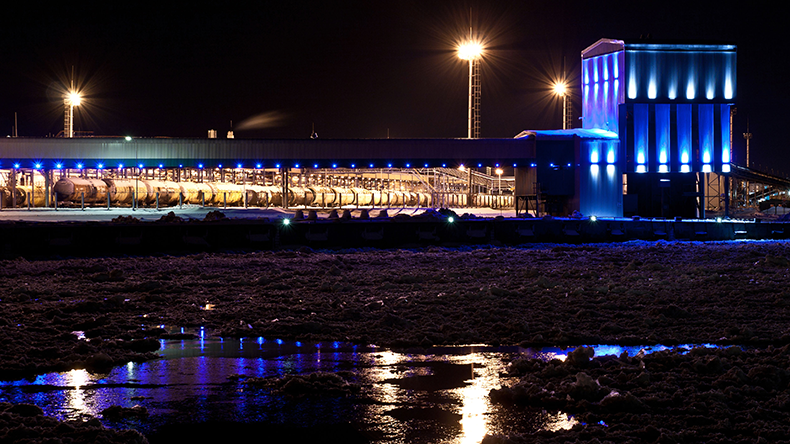 Port ammonia complex with a frozen river front in the winter night
