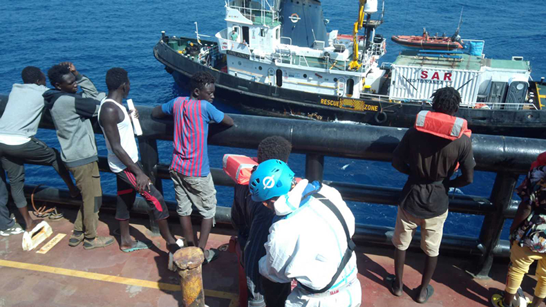Migrants on Maersk Etienne before being transferred to Mare Jonio (alongside)