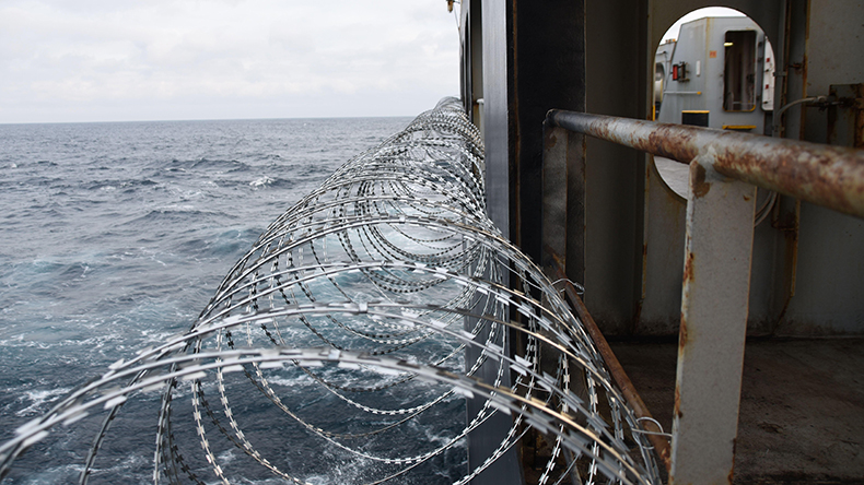 Barbed wire attached to the ship hull, against piracy attack in the Gulf of Guinea Credit: Lucia Gajdosikova / Alamy Stock Photo