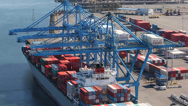 A container vessel and cranes at Seaport Alliance's Husky Terminal