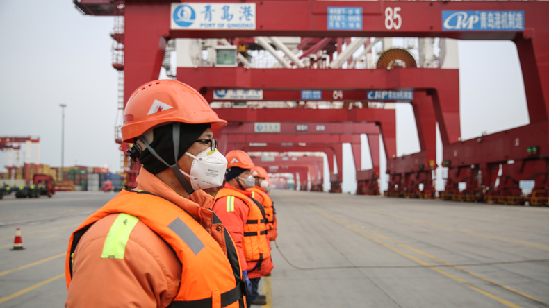 Workers at Qingdao port wearing anti-coronavirus masks.