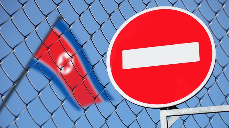 Sanctions: North Korea flag and No Entry sign. Credit Vladimirkarp/Shutterstock.com