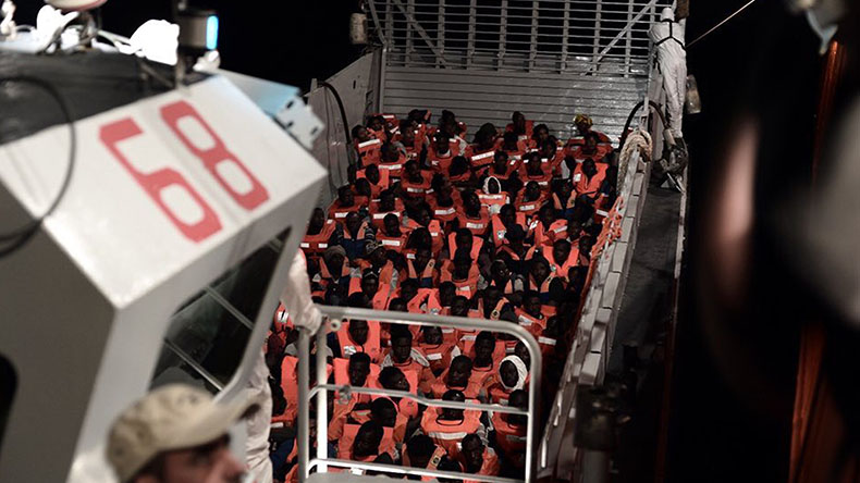 This undated photo released by by French NGO "SOS Mediterranee" on Monday June 11, 2018 and posted on it's Twitter account, shows migrants about to board the SOS Mediterranee's Aquarius ship and MSF (Doctors Without Borders) NGOs, in the Mediterranean Sea. Italy and Malta dug in for a second day and refused to let the rescue ship Aquarius with 629 people aboard dock in their ports, leaving the migrants at sea as a diplomatic standoff escalated under Italy's new anti-immigrant government. (Kenny Karpov/SOS Mediterranee via AP)