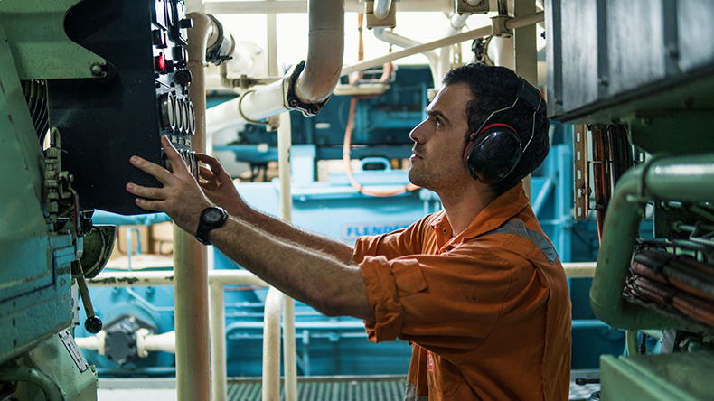 Marine engineer inspecting ship engine Credit: Igor Kardasov / Alamy Stock Photo