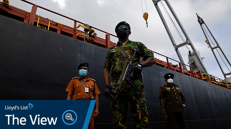 Security personnel stand in front of a cargo ship carrying humanitarian aid from India, amid the country's economic crisis, at a port in Colombo, Sri Lanka, May 22, 2022. Credit: REUTERS / Adnan Abidi / Alamy Stock Photo 