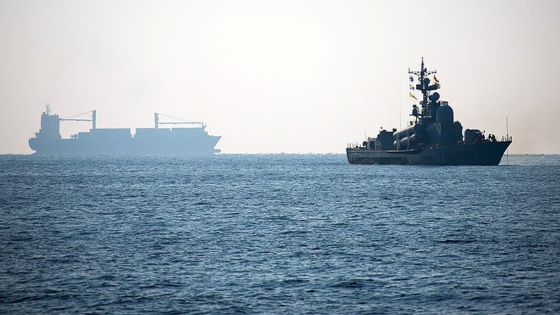 Russian naval vessel with containership in background