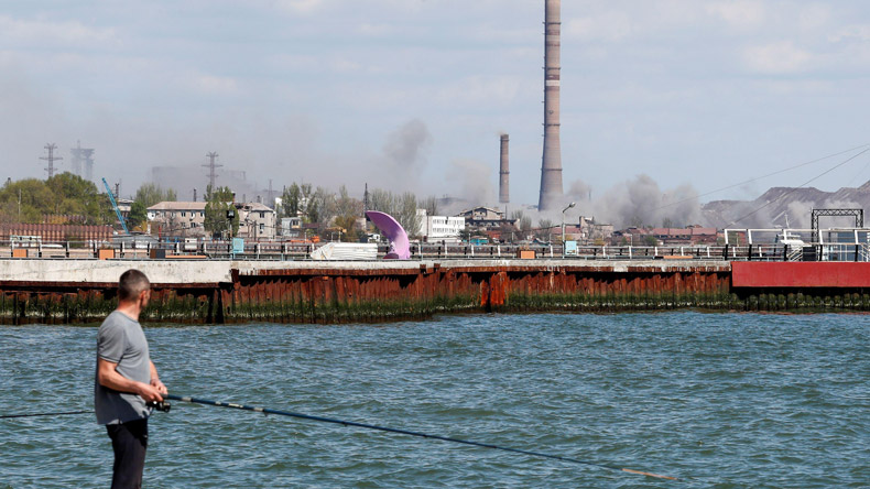 Angler at Mariupol sees smoke from  Azovstal steel works.