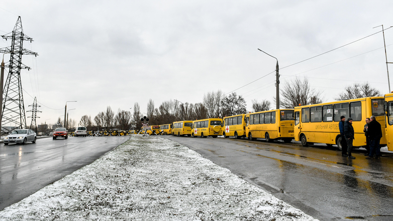 Buses lined up outside Mariupol ro deliver aid and take out refugees.  Credit Abaca Press / Alamy Stock Photo