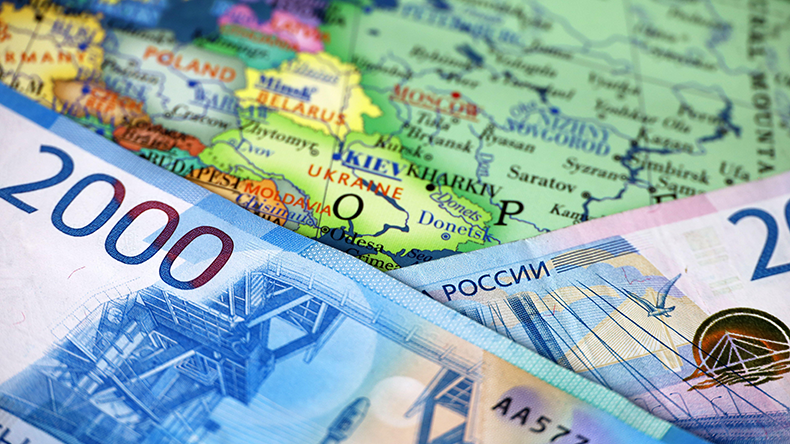  Russian rubles on map of Ukraine and Russia